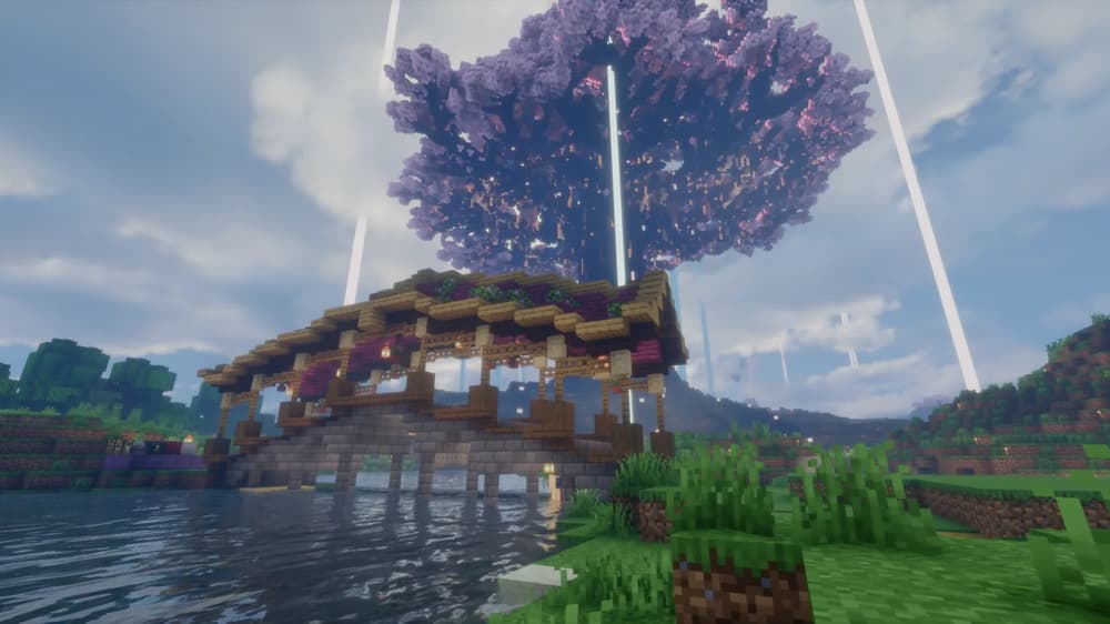 Covered wooden bridge across a river, with the huge cherry blossom canopy of Yggdrasil behind it