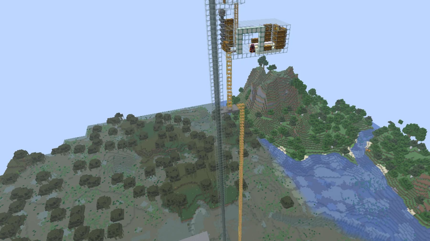 Tall, see-through tower with a wood-and-glass chamber at the top, beside yellow scaffolds, with forest and a river in the background
