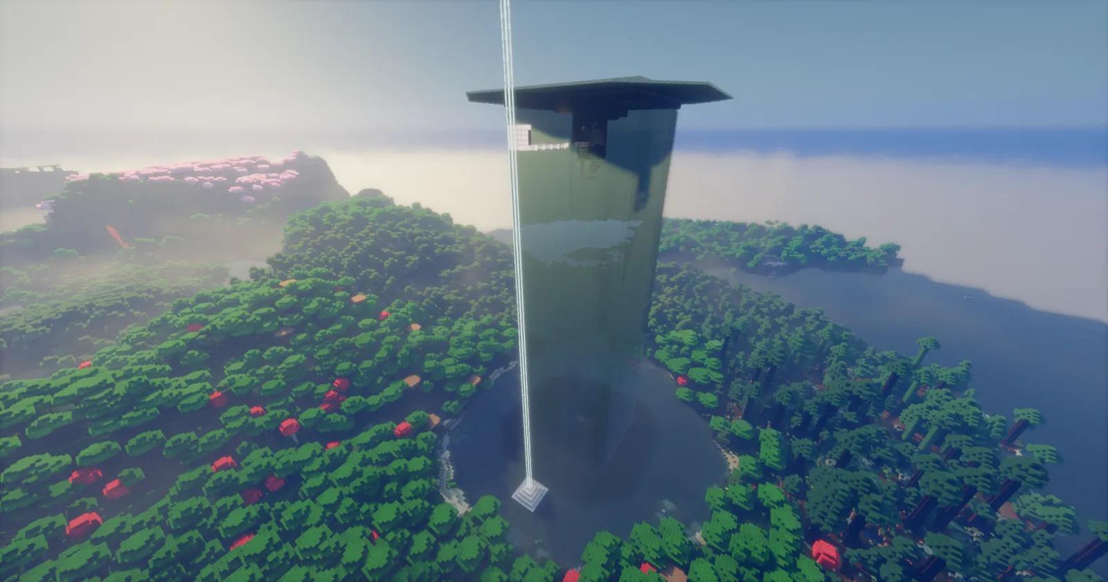 Tall dark green farm tower with an overhanging roof, surrounded by forest and a pool of water, with a beacon beam beside it