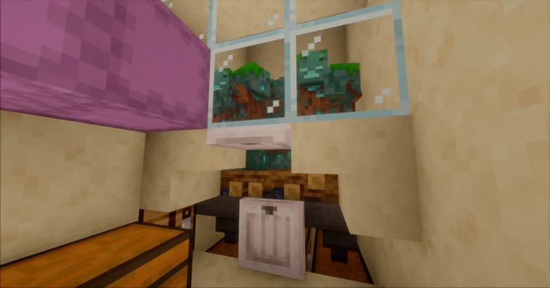 Two drowned behind glass panes in a sandstone wall, with a hopper and chests below