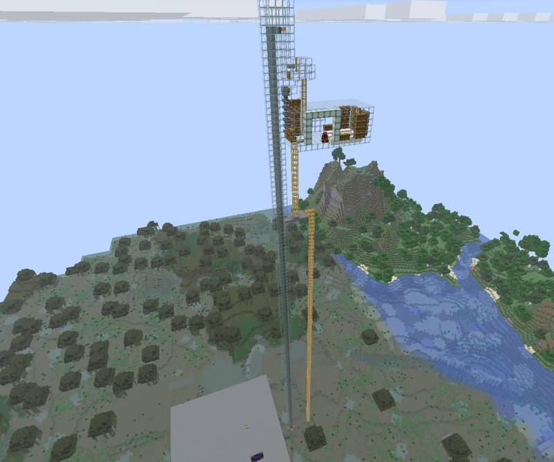Tall, see-through tower with a wood-and-glass chamber at the top, beside yellow scaffolds, with forest and a river in the background